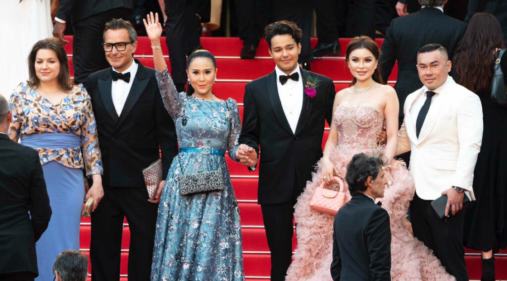 First Lady of Iceland Eliza Reid, Michael Coste from Hermes, and Jessica Chaijaya waving on the red carpet at the USC awareness event during Cannes Film Festival 2023