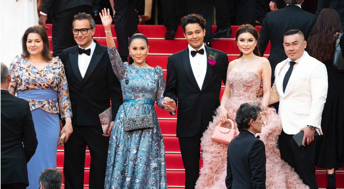 First Lady of Iceland Eliza Reid, Michael Coste from Hermes, and Jessica Chaijaya waving on the red carpet at the USC awareness event during Cannes Film Festival 2023