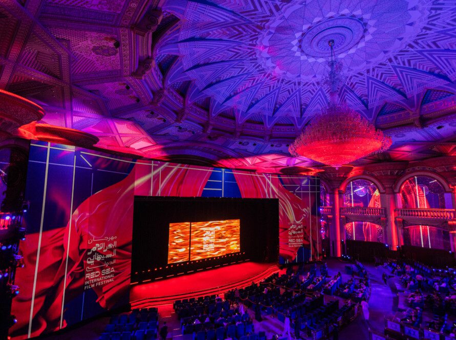 Panoramic view of the Red Sea Film Festival’s main screening theater, showcasing modern architecture and tiered seating under ambient lighting.
