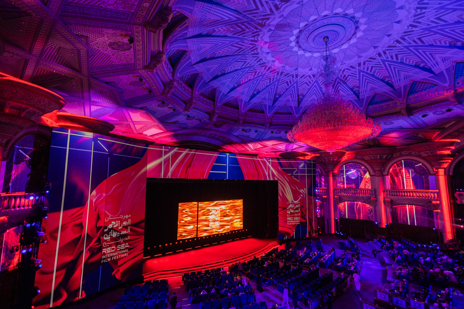 Panoramic view of the Red Sea Film Festival’s main screening theater, showcasing modern architecture and tiered seating under ambient lighting.