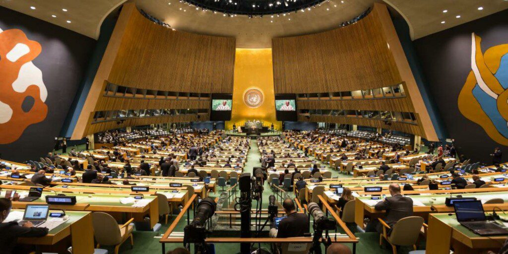 Wide-angle view of UN Headquarters meeting chamber with delegates