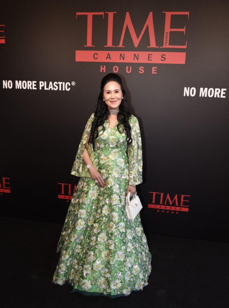 Jessica Chaijaya, President of the United Society Council, posing in front of the branded media wall at the TIME France charity gala