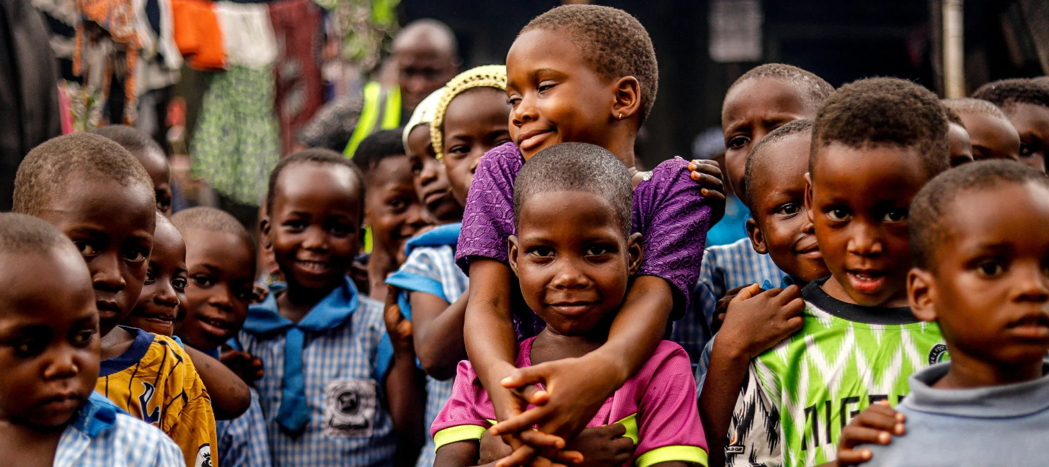 Happy African children at a community foodbank, symbolizing The United Society Council's mission of empowering inclusive communities.